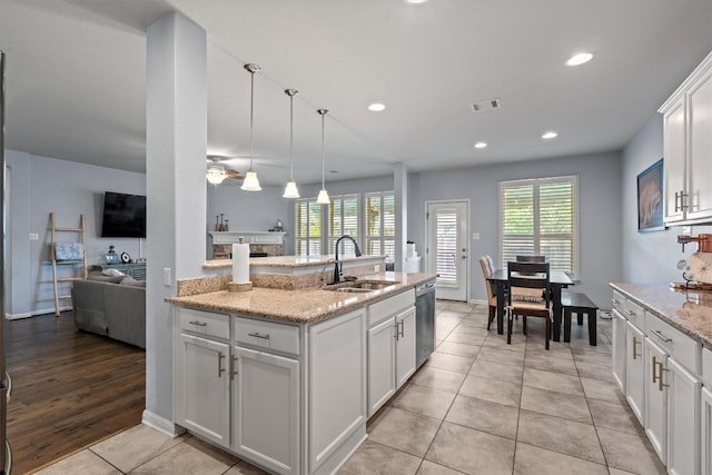13625 Glen Creek Ct, Manor, TX 78653 - kitchen with a sink, stainless steel dishwasher, healthy amount of natural light, white cabinets, and recessed lighting