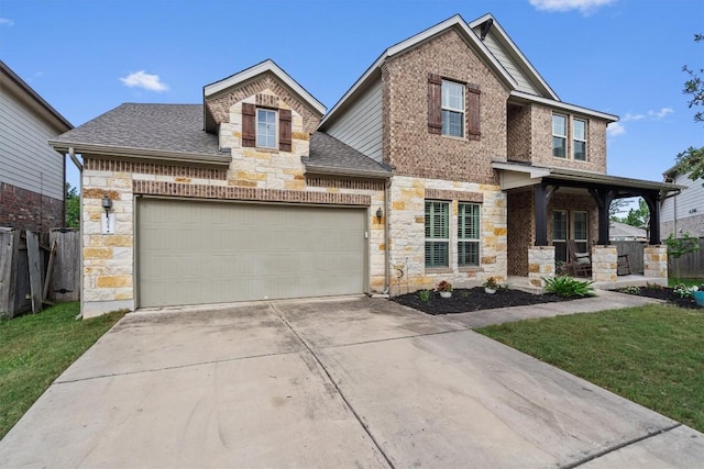 13625 Glen Creek Ct, Manor, TX 78653 - view of front of home with stone siding, a garage, driveway, roof with shingles, and brick siding