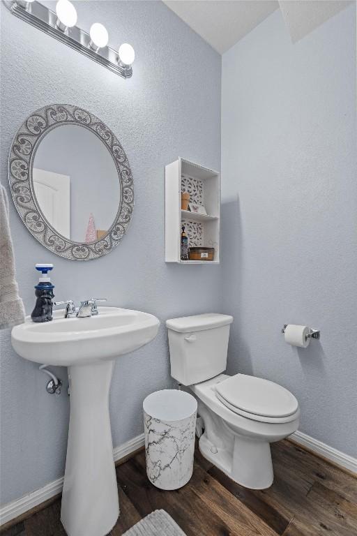 13625 Glen Creek Ct, Manor, TX 78653 - bathroom with wood finished floors, toilet, a sink, and baseboards