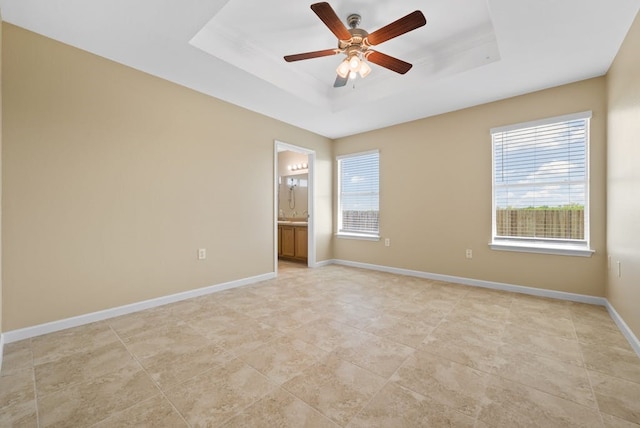 6317 Vida Nueva Ave, Del Valle, TX 78617 - spare room with a tray ceiling, healthy amount of natural light, ceiling fan, and light tile patterned flooring