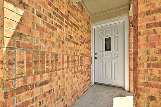 6317 Vida Nueva Ave, Del Valle, TX 78617 - view of exterior entry featuring brick siding and a porch