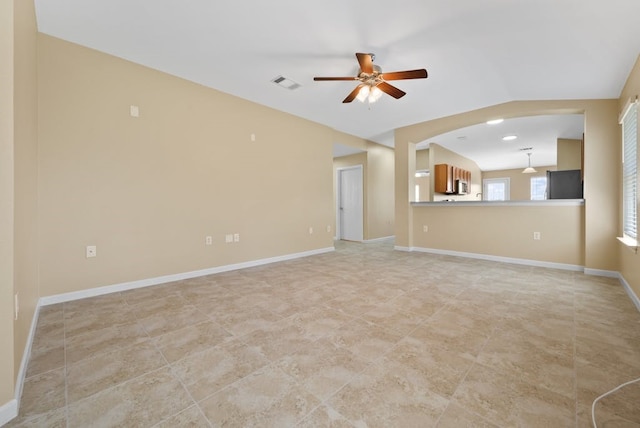 6317 Vida Nueva Ave, Del Valle, TX 78617 - unfurnished living room featuring ceiling fan, light tile patterned floors, lofted ceiling, and arched walkways