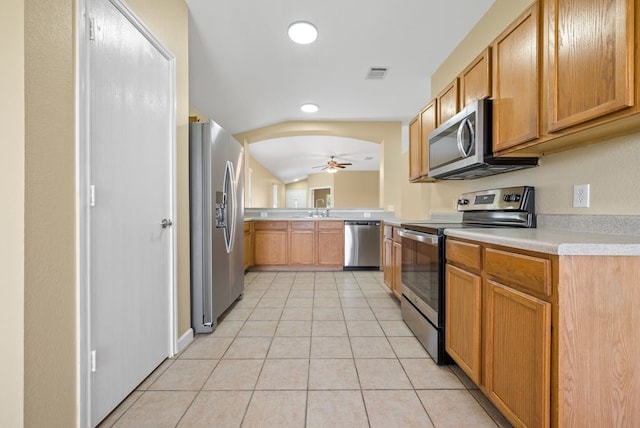 6317 Vida Nueva Ave, Del Valle, TX 78617 - kitchen featuring stainless steel appliances, ceiling fan, light countertops, light tile patterned floors, and recessed lighting