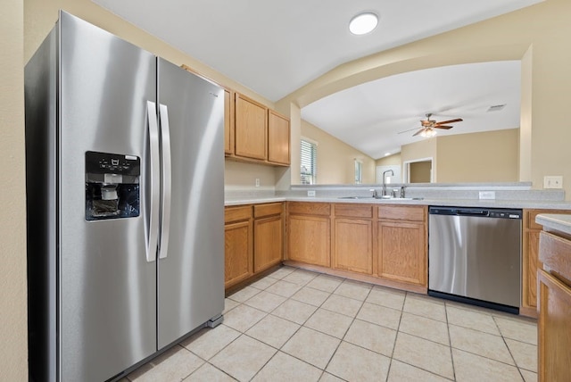 6317 Vida Nueva Ave, Del Valle, TX 78617 - kitchen featuring appliances with stainless steel finishes, vaulted ceiling, ceiling fan, light countertops, and light tile patterned flooring
