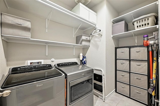 1304 Eagle Ridge Trl, Leander, TX 78641 - laundry area with independent washer and dryer, light tile patterned floors, and a textured wall