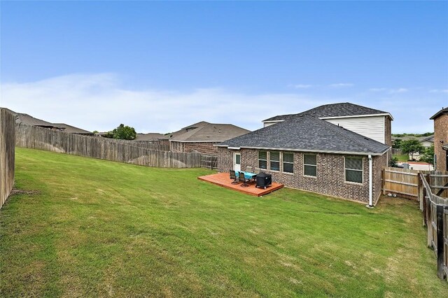 1304 Eagle Ridge Trl, Leander, TX 78641 - rear view of property with a fenced backyard, a deck, roof with shingles, and brick siding