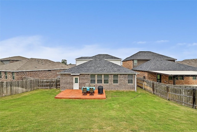 1304 Eagle Ridge Trl, Leander, TX 78641 - back of house with a fenced backyard, brick siding, a wooden deck, and a shingled roof