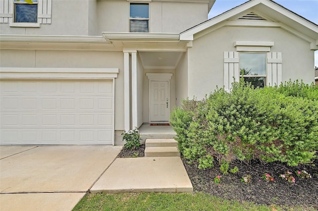 1304 Eagle Ridge Trl, Leander, TX 78641 - view of exterior entry featuring a garage, stucco siding, and driveway