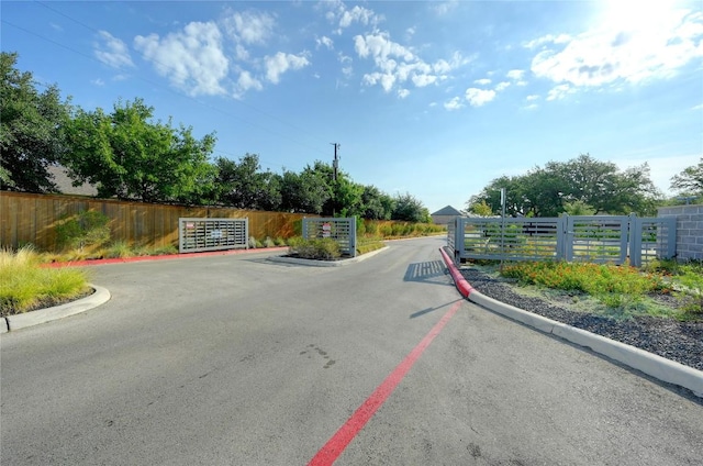 1304 Eagle Ridge Trl, Leander, TX 78641 - view of asphalt road with curbs and a gated entry