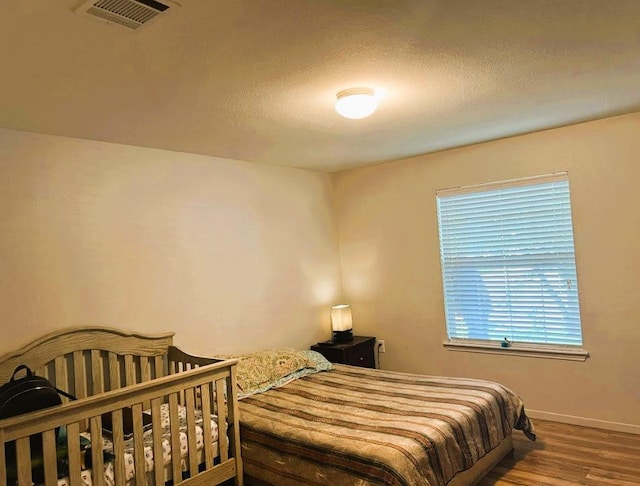 5105 Bantom Woods Bnd, Austin, TX 78724 - bedroom with wood finished floors, baseboards, and a textured ceiling