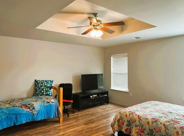 5105 Bantom Woods Bnd, Austin, TX 78724 - bedroom featuring a tray ceiling, wood finished floors, baseboards, and a ceiling fan