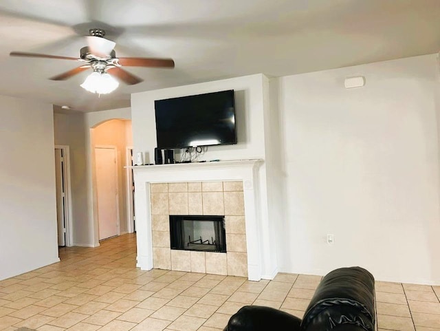 5105 Bantom Woods Bnd, Austin, TX 78724 - living area with arched walkways, ceiling fan, a fireplace, and light tile patterned flooring