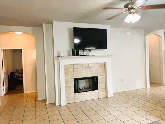 5105 Bantom Woods Bnd, Austin, TX 78724 - living area with a ceiling fan, a fireplace, arched walkways, and light tile patterned flooring