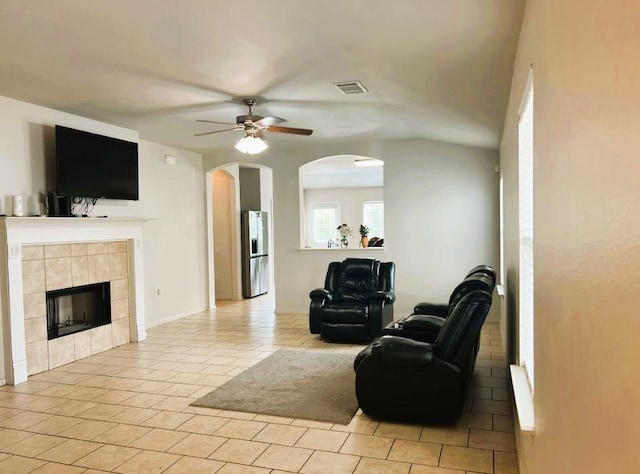 5105 Bantom Woods Bnd, Austin, TX 78724 - living area featuring ceiling fan, arched walkways, a fireplace, and light tile patterned floors