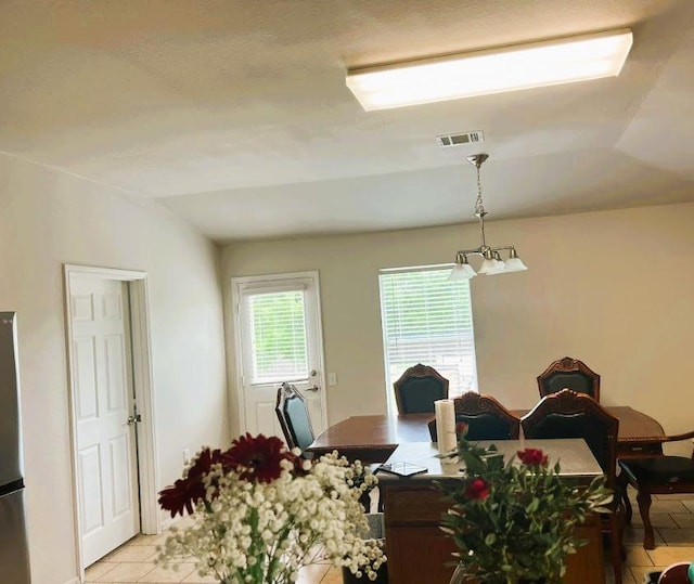 5105 Bantom Woods Bnd, Austin, TX 78724 - dining room with light tile patterned floors and vaulted ceiling