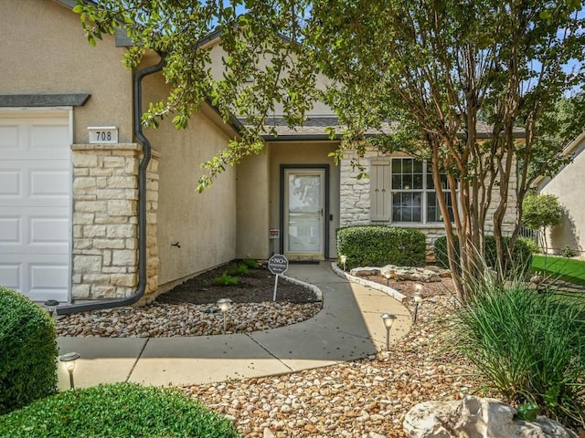 708 Texas Dr, Georgetown, TX 78633 - doorway to property featuring stucco siding, stone siding, and a garage