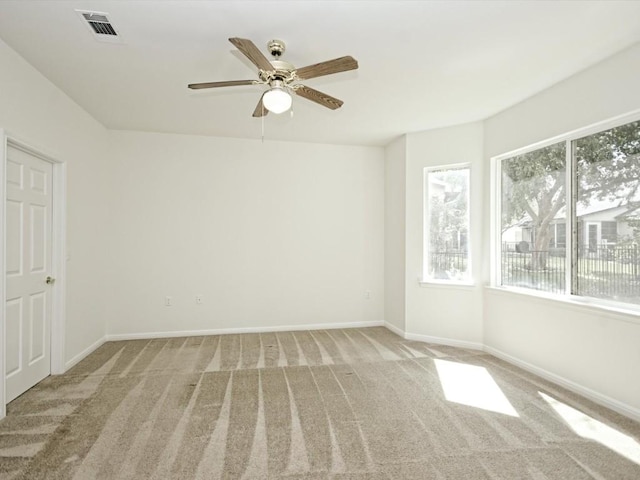 708 Texas Dr, Georgetown, TX 78633 - empty room featuring plenty of natural light, carpet flooring, ceiling fan, and baseboards