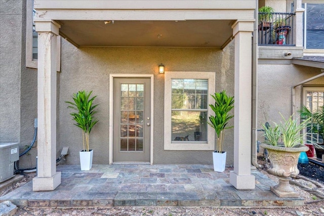 11203 Ranch Road 2222 1304, Austin, TX 78730 - entrance to property with stucco siding, central AC, and a patio