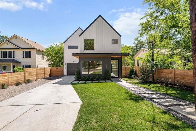 1305 Walnut Ave, Austin, TX 78702 - view of front of house featuring board and batten siding, concrete driveway, and an attached garage
