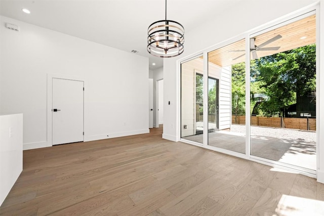 1305 Walnut Ave, Austin, TX 78702 - unfurnished dining area with wood finished floors, a chandelier, ceiling fan, recessed lighting, and baseboards