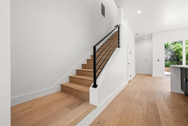 1305 Walnut Ave, Austin, TX 78702 - stairway with wood finished floors, baseboards, and recessed lighting
