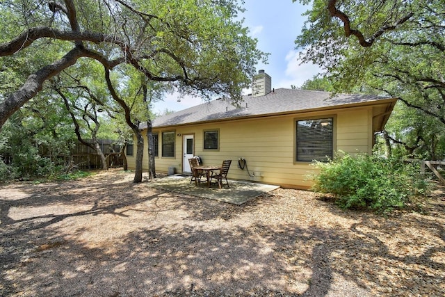 9912 Little Creek Cir, Dripping Springs, TX 78620 - rear view of house featuring a chimney and a patio area