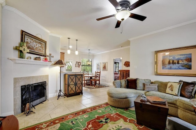 9912 Little Creek Cir, Dripping Springs, TX 78620 - living area featuring light tile patterned floors, ornamental molding, baseboards, ceiling fan, and a tiled fireplace