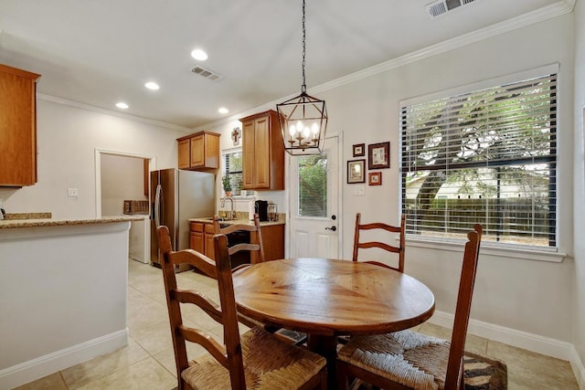 9912 Little Creek Cir, Dripping Springs, TX 78620 - dining area with crown molding, light tile patterned flooring, healthy amount of natural light, recessed lighting, and a chandelier