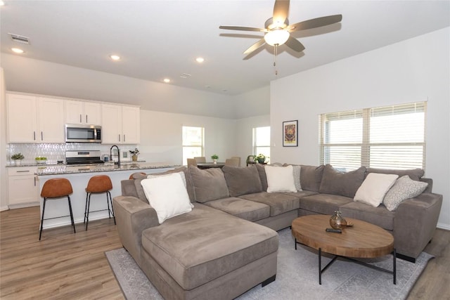 2208 Mcclendon Trl, Leander, TX 78641 - living area featuring light wood-type flooring, a ceiling fan, and recessed lighting