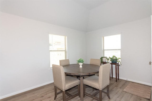 2208 Mcclendon Trl, Leander, TX 78641 - dining area featuring light wood-type flooring, baseboards, and high vaulted ceiling
