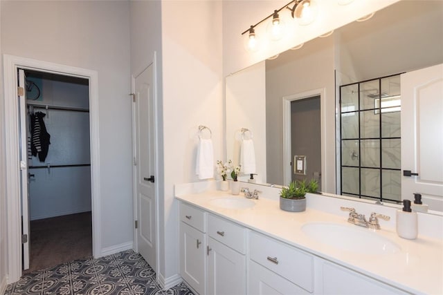 2208 Mcclendon Trl, Leander, TX 78641 - bathroom with double vanity, a shower stall, a spacious closet, tile patterned flooring, and baseboards