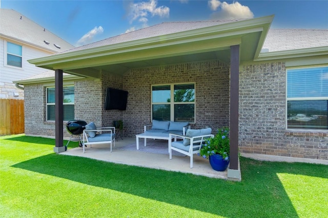 2208 Mcclendon Trl, Leander, TX 78641 - rear view of property featuring a patio, brick siding, and an outdoor hangout area