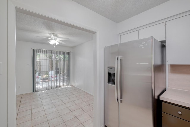 7400 Ophelia Dr, Austin, TX 78752 - kitchen with stainless steel refrigerator with ice dispenser, a textured ceiling, ceiling fan, light tile patterned flooring, and light countertops