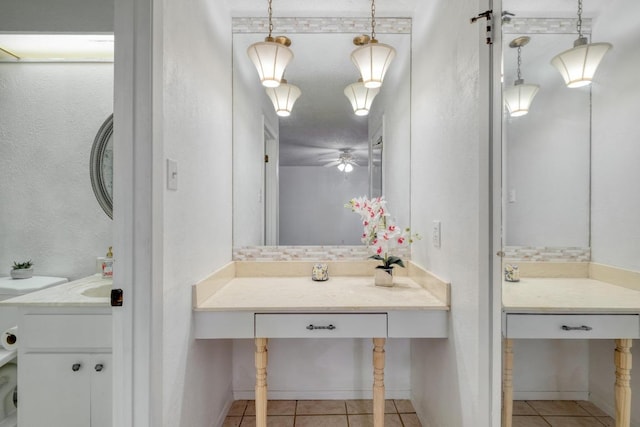 7400 Ophelia Dr, Austin, TX 78752 - bathroom featuring tile patterned floors, ceiling fan, vanity, and a textured wall