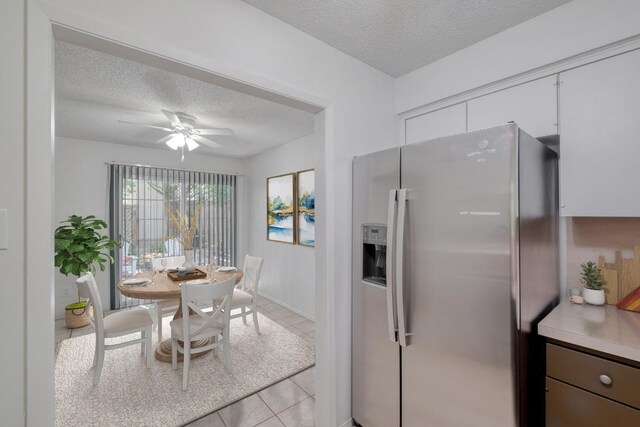 7400 Ophelia Dr, Austin, TX 78752 - dining room featuring a textured ceiling, light tile patterned floors, and a ceiling fan