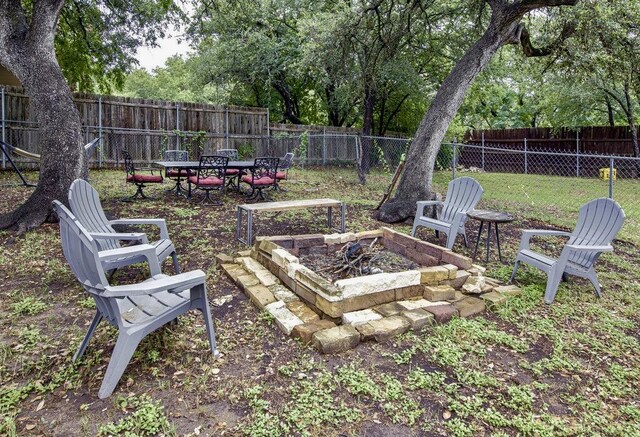 15100 N Flamingo Dr, Austin, TX 78734 - fenced backyard with a fire pit and outdoor dining space