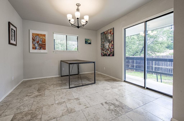 15100 N Flamingo Dr, Austin, TX 78734 - unfurnished dining area featuring a chandelier, baseboards, and stone finish floors