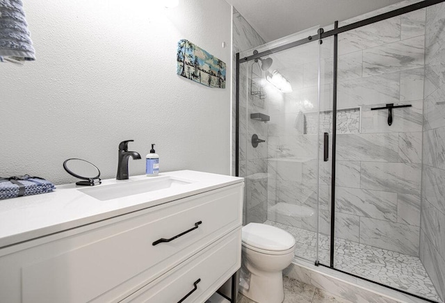 15100 N Flamingo Dr, Austin, TX 78734 - bathroom featuring toilet, vanity, a stall shower, and a textured wall