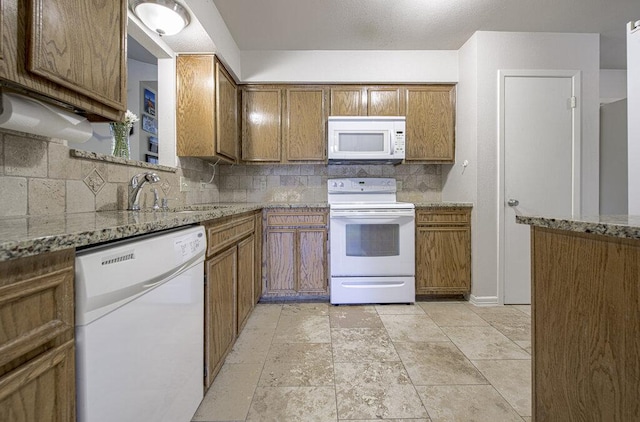 15100 N Flamingo Dr, Austin, TX 78734 - kitchen with white appliances, brown cabinetry, a sink, and backsplash