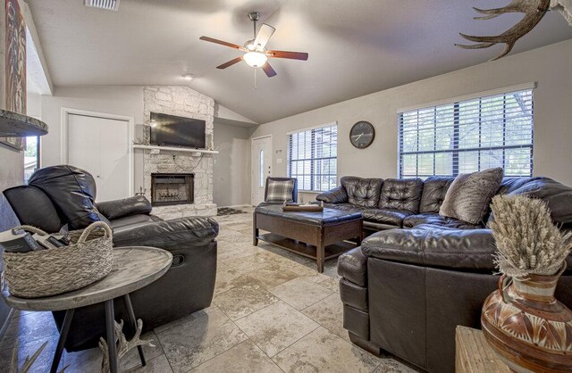 15100 N Flamingo Dr, Austin, TX 78734 - living area featuring a ceiling fan, lofted ceiling, and a stone fireplace