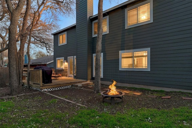 2714 Inridge Dr, Austin, TX 78745 - rear view of house featuring a fire pit, a chimney, and a deck