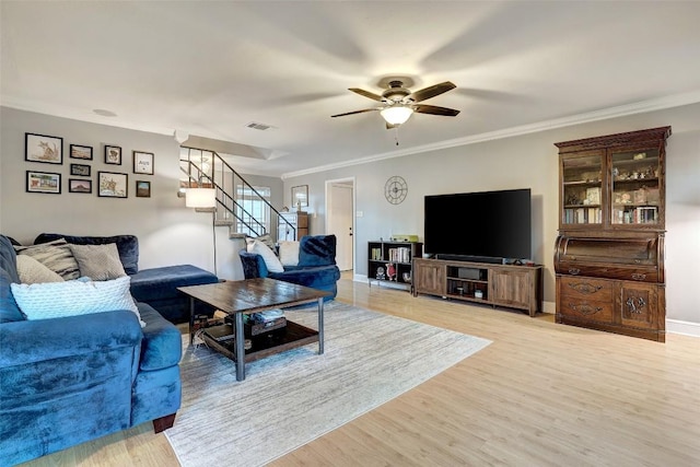 2714 Inridge Dr, Austin, TX 78745 - living area with stairway, a ceiling fan, light wood-style floors, crown molding, and baseboards