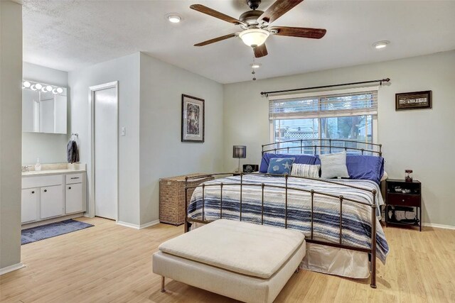 2714 Inridge Dr, Austin, TX 78745 - bedroom with baseboards, light wood-type flooring, ensuite bath, and ceiling fan