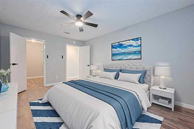 7614 Andiron Cir, Houston, TX 77041 - bedroom with baseboards, wood finished floors, and a ceiling fan
