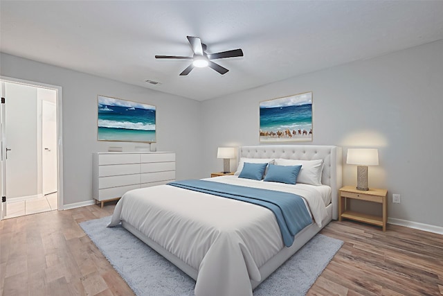 7614 Andiron Cir, Houston, TX 77041 - bedroom with wood finished floors, baseboards, and ceiling fan