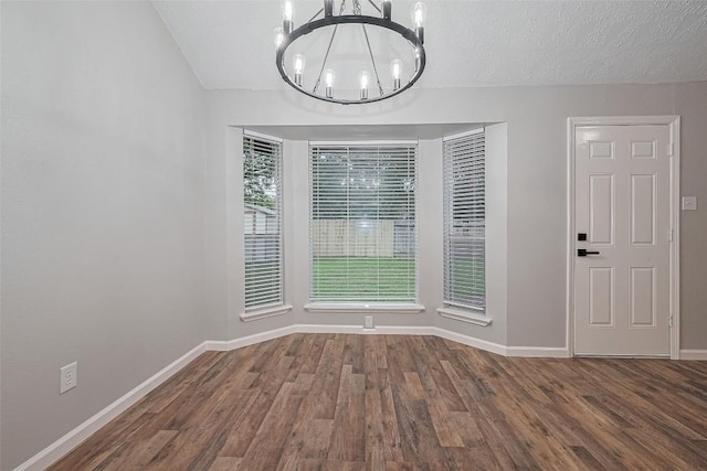 7614 Andiron Cir, Houston, TX 77041 - unfurnished dining area with a chandelier, wood finished floors, and baseboards