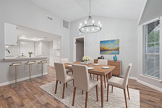 7614 Andiron Cir, Houston, TX 77041 - dining room with high vaulted ceiling, a chandelier, wood finished floors, and baseboards