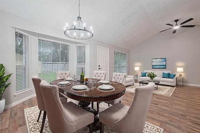 7614 Andiron Cir, Houston, TX 77041 - dining room with vaulted ceiling, a chandelier, baseboards, light wood-style floors, and ceiling fan