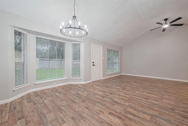7614 Andiron Cir, Houston, TX 77041 - interior space featuring a chandelier, wood finished floors, vaulted ceiling, a textured ceiling, and baseboards