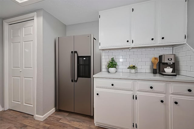 7614 Andiron Cir, Houston, TX 77041 - kitchen featuring stainless steel fridge, light countertops, wood finished floors, and white cabinetry